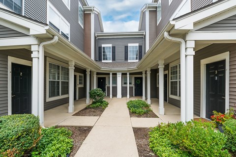 A row of houses with a walkway in the middle.