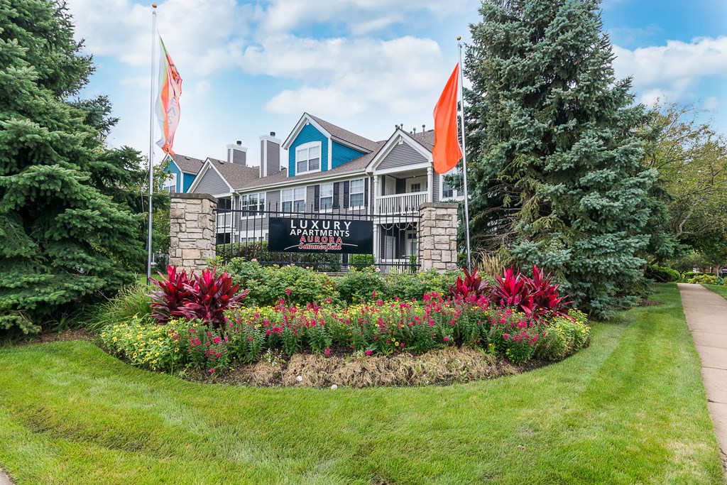 A building with a sign that says "LUXURY APARTMENTS" in front of it.