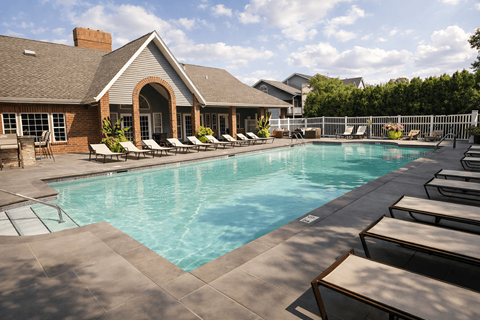 A pool with a building in the background.