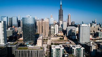A cityscape with a variety of buildings, including a prominent one with a spire.