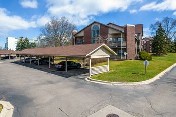 covered parking outside The Addison at Southfield apartment building in Southfield