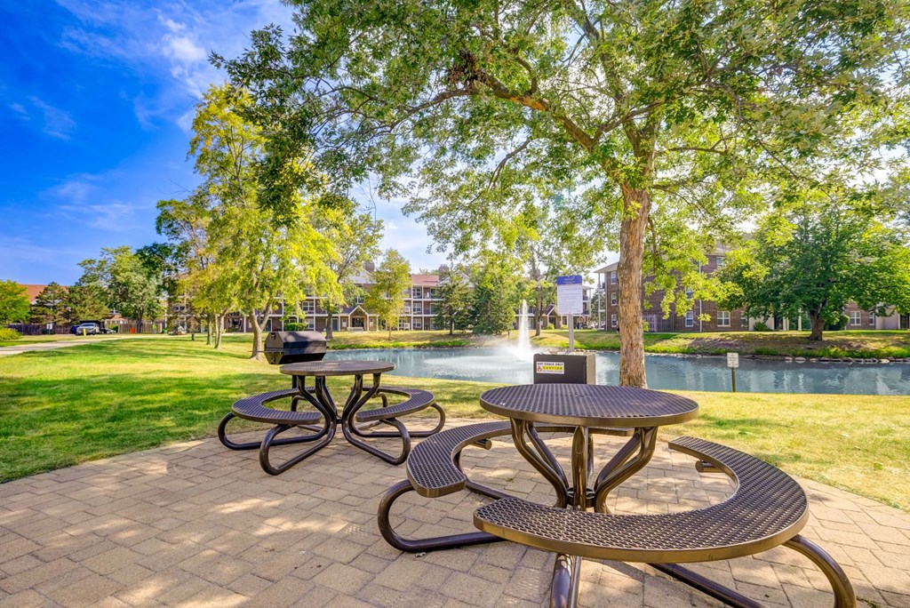 A picnic table and bench are set up in a park.