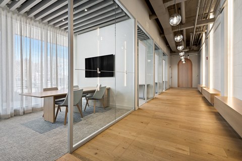 A conference room with a long table and chairs.