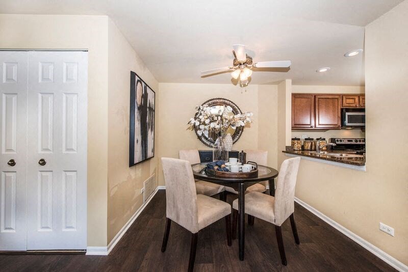 a dining room with a table and chairs