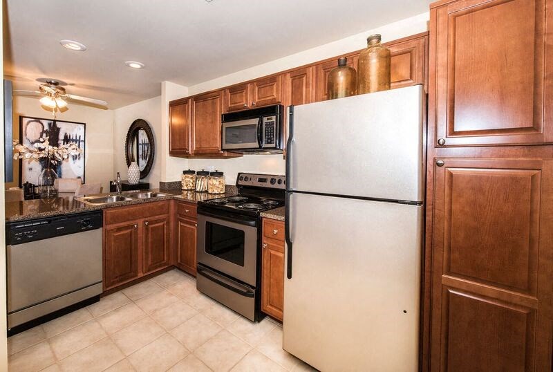 a kitchen with stainless steel appliances and wooden cabinets