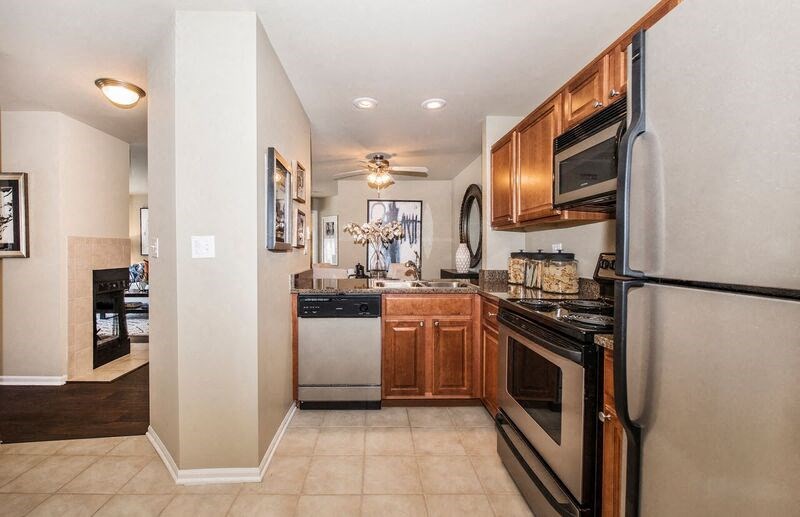a kitchen with stainless steel appliances and wooden cabinets