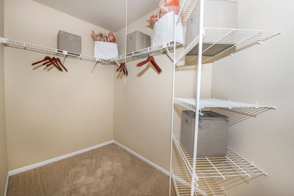 our spacious closets are stocked with clothes and shoes in our spacious walk in closet