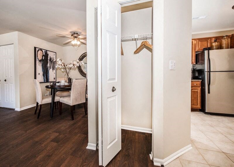 a kitchen and living room with a refrigerator and a table