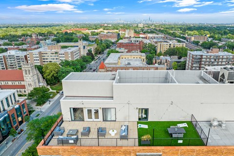 an aerial view of a building with a green roof and the philadelphia skyline in the background