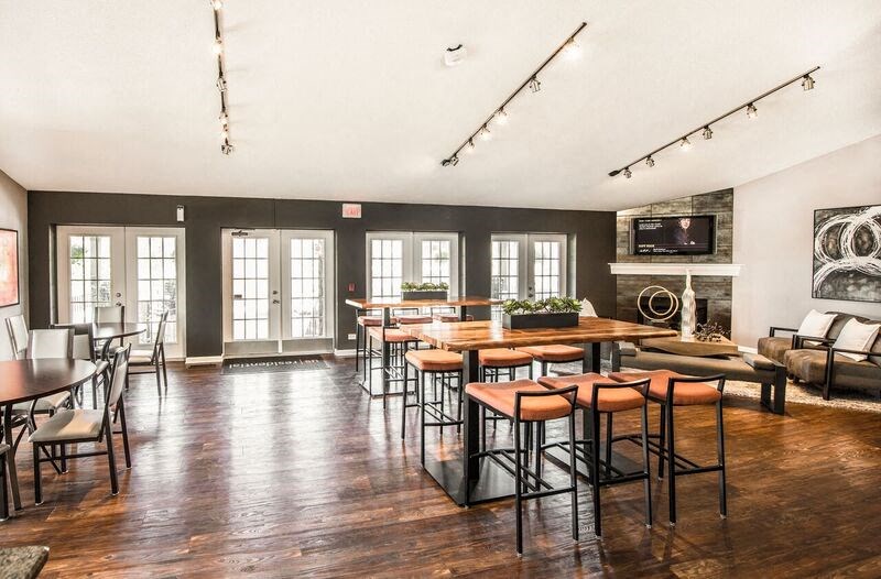a large living room with tables and chairs