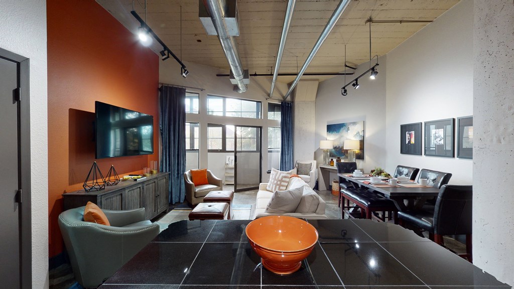 a living room and dining room in a loft apartment