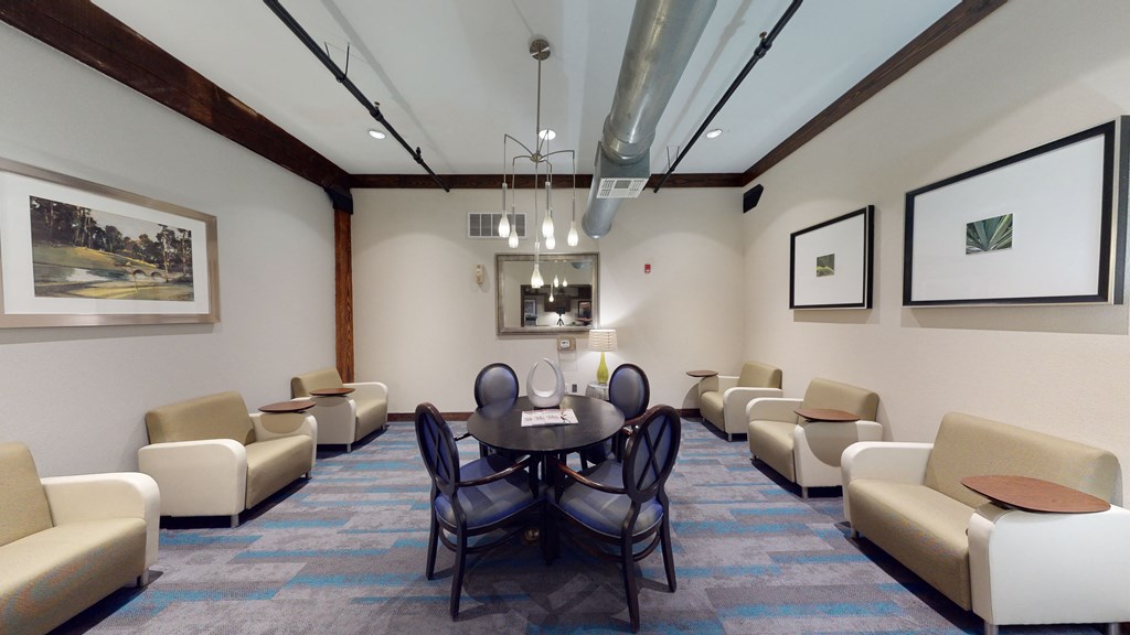 a conference room with couches chairs and a table
