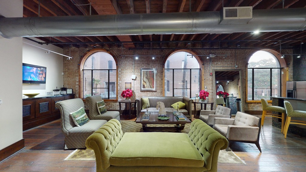 a large living room with furniture and large windows