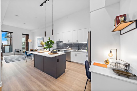A modern kitchen with a dining table and chairs.