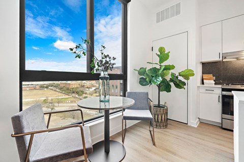 A modern dining room with a table and chairs.