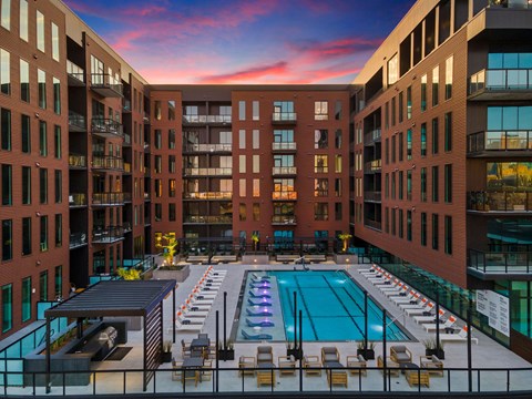 A large indoor swimming pool surrounded by brick buildings.
