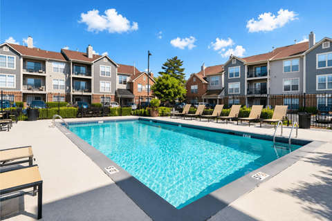A swimming pool in front of apartment buildings.