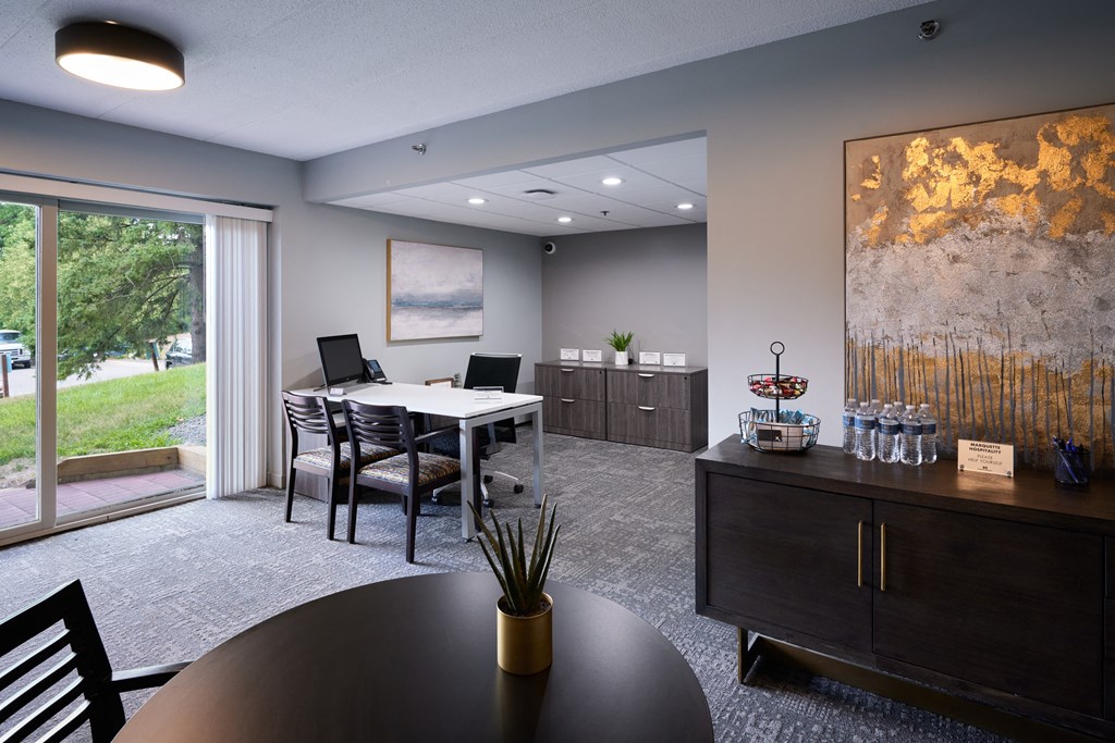 a conference room with a table and chairs and a sliding glass door