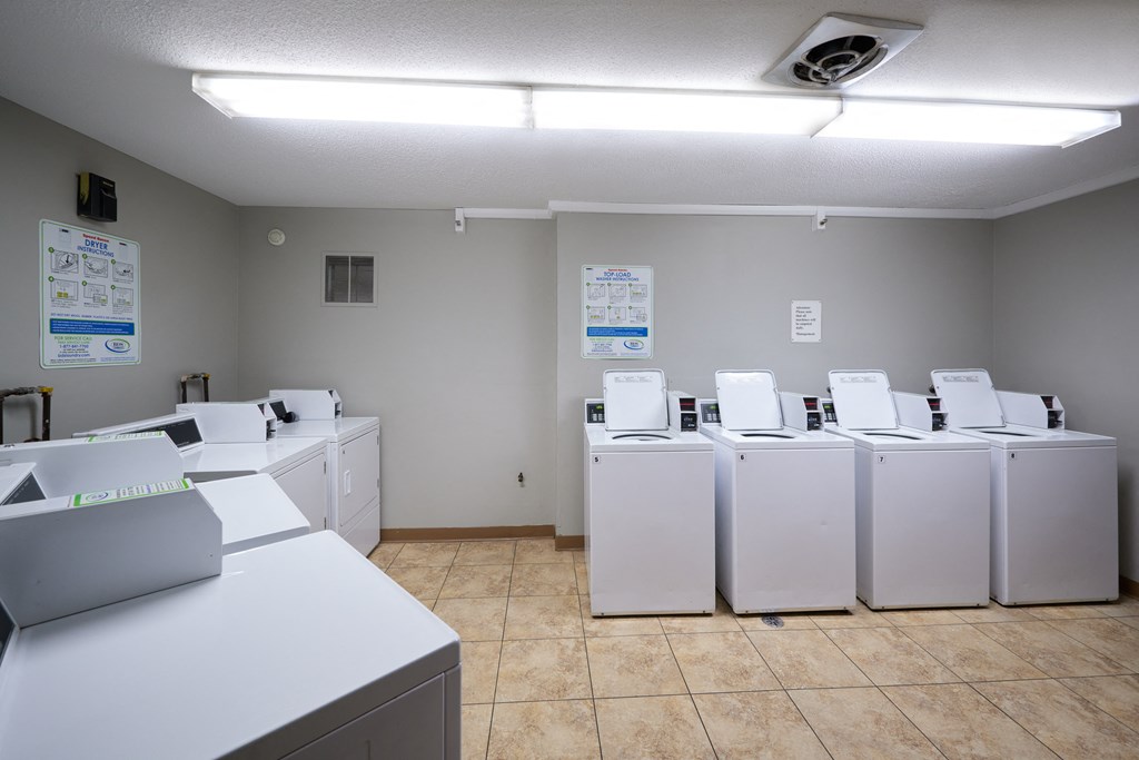 a laundry room filled with washers and dryer machines