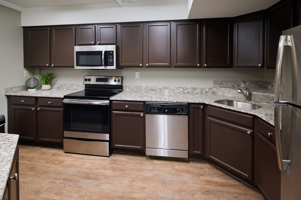 a kitchen with stainless steel appliances and granite counter tops