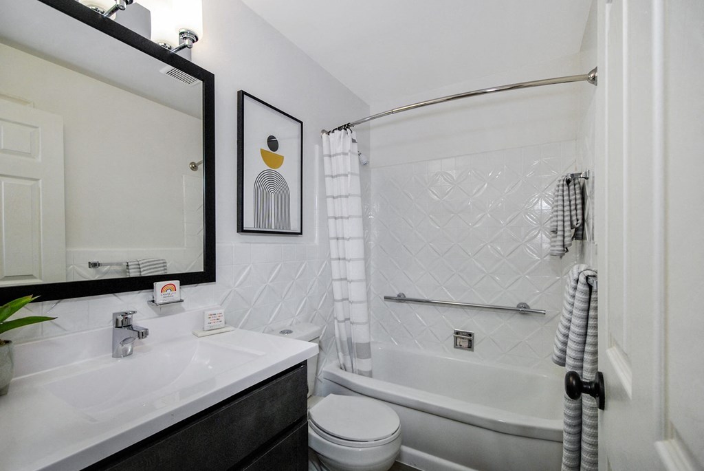 a bathroom with a shower and a sink and a mirror