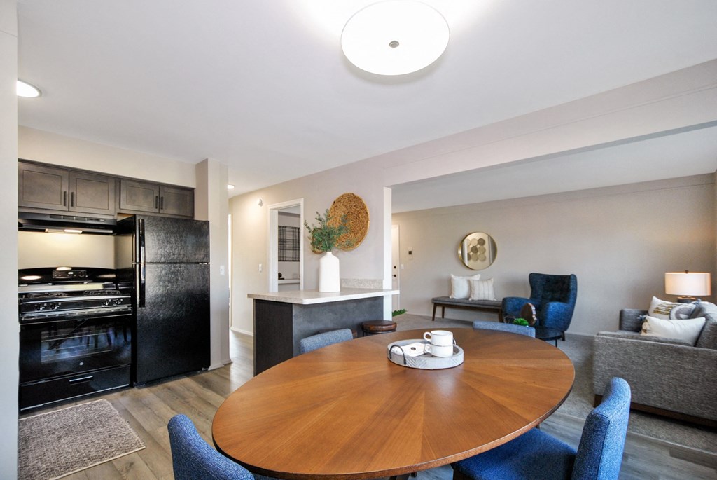 a living room with a dining room table and a kitchen