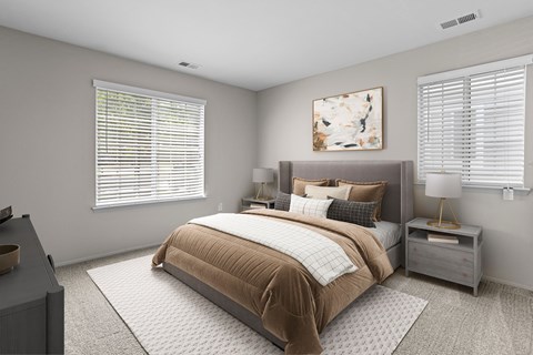 A bedroom with a large bed and a nightstand with a lamp.