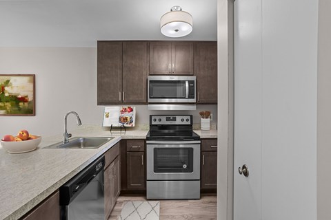 A modern kitchen with a stainless steel oven and microwave.