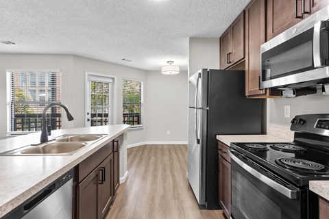 A kitchen with a black refrigerator and stove.