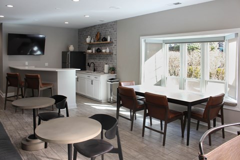 A modern kitchen with a dining table and chairs.