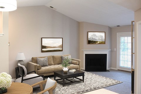 A living room with a fireplace and a painting on the wall.