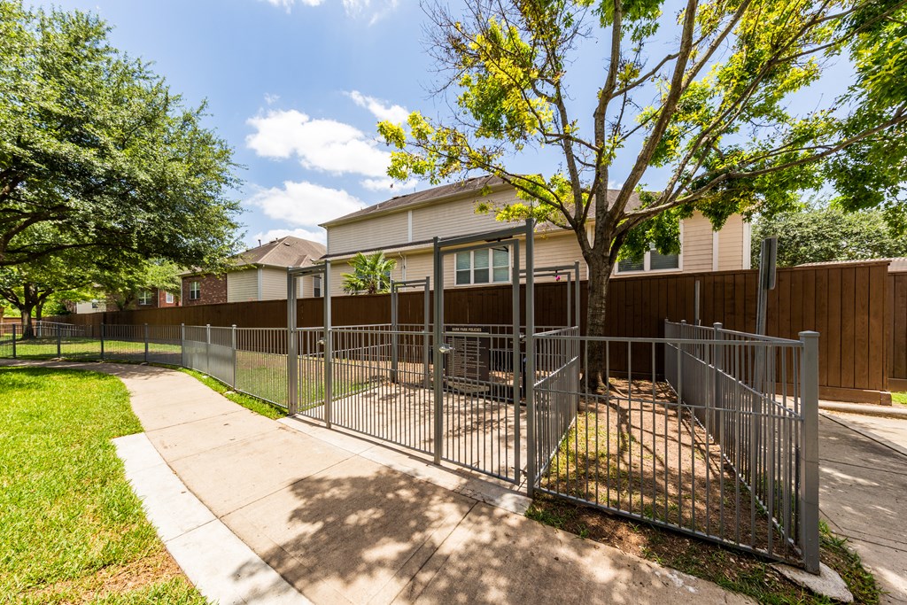 our apartments have a fenced in area with a sidewalk and a fence