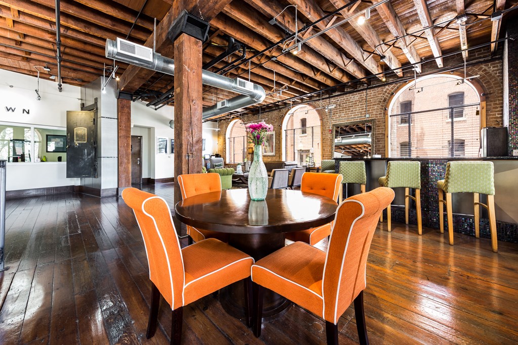 a dining room with a table and chairs in a loft