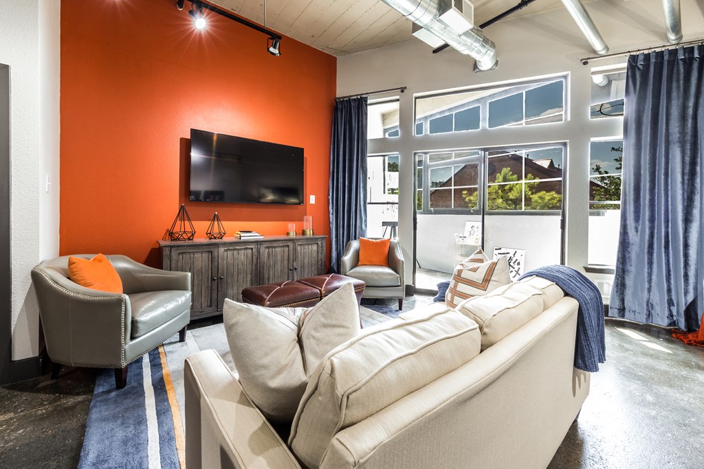 spacious living room with an attached private balcony in a Houston apartment