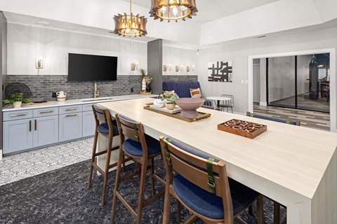 a kitchen with a large table and chairs