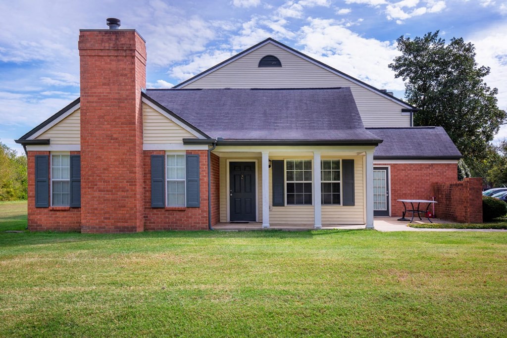 a house with a red brick facade and a black door