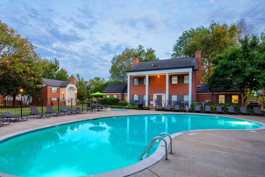 a swimming pool with a house in the background