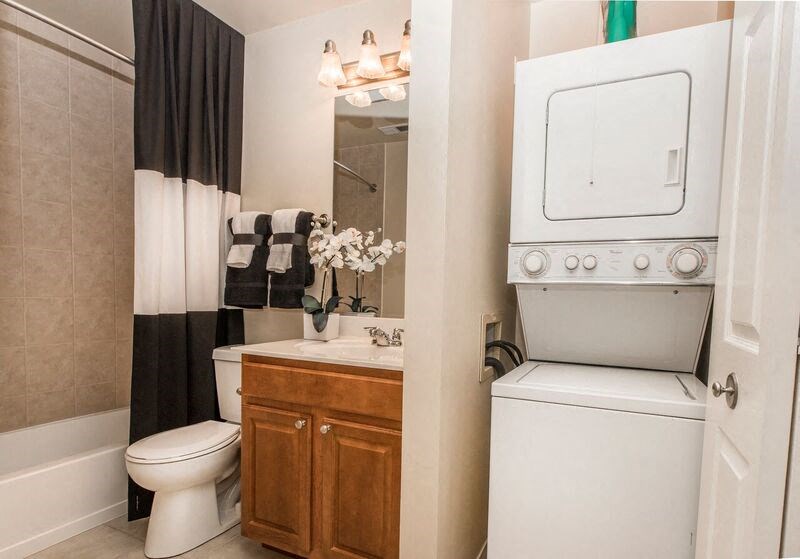 a bathroom with a toilet and a sink and a mirror