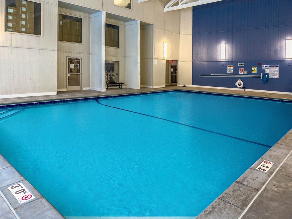 a large blue pool in a lobby of a building