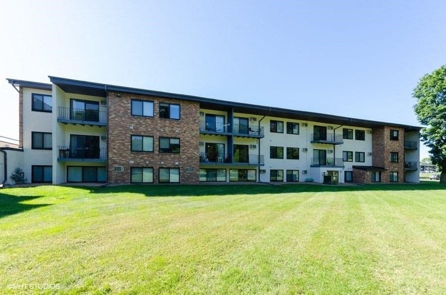 a large lawn in front of an apartment building