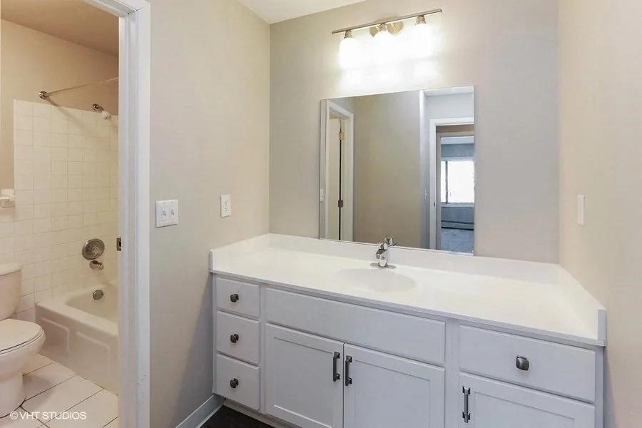 a white bathroom with a sink and a mirror