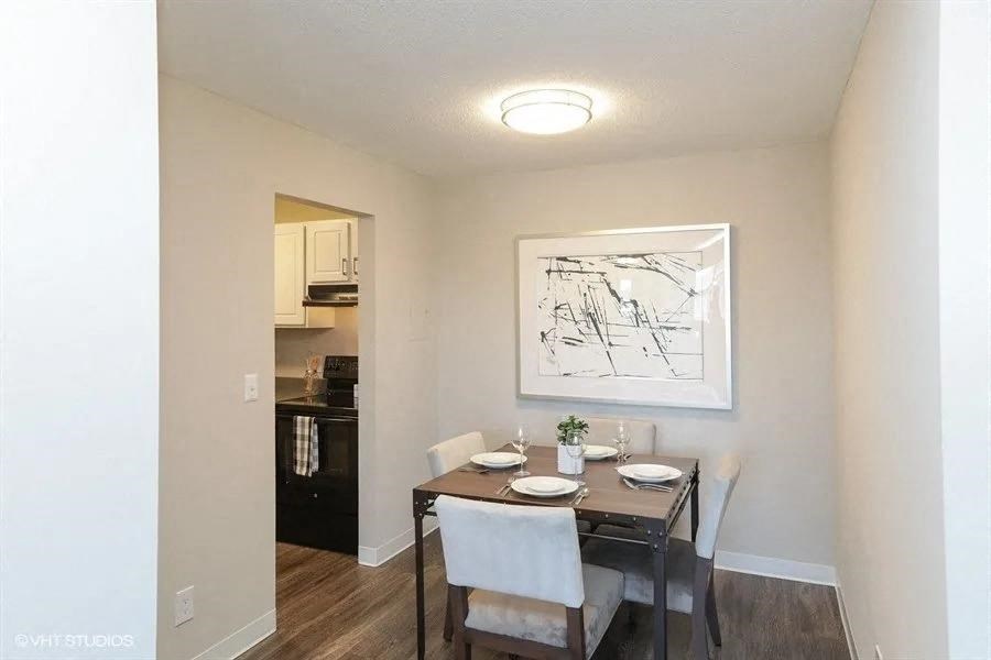 an empty dining room with a table and chairs