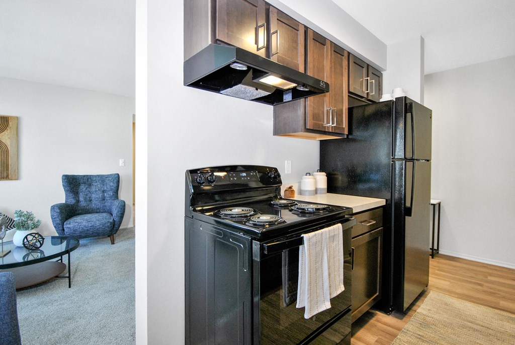 updated kitchen with black appliances and brown cabinets
