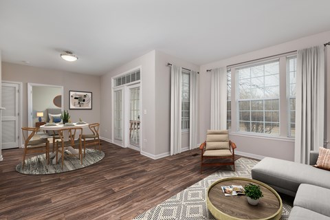 A living room with a wooden floor and a grey sofa.