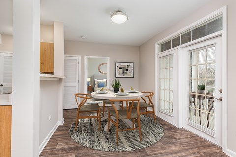 A dining room with a table set for two.