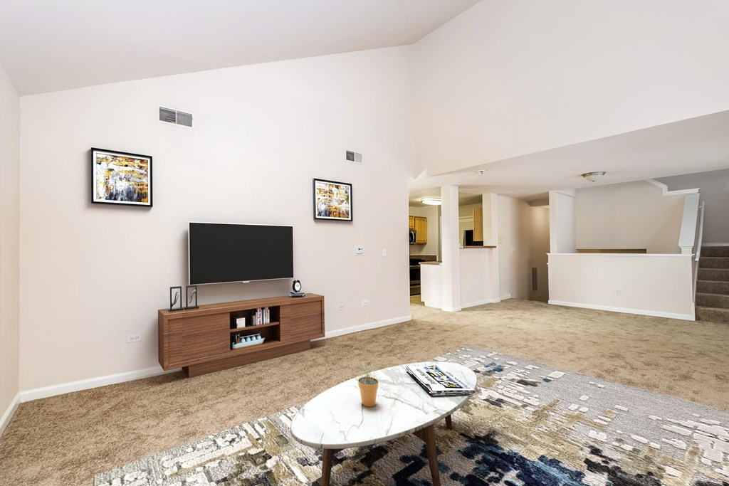 A living room with a white table and a television.