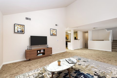 A living room with a white table and a television.
