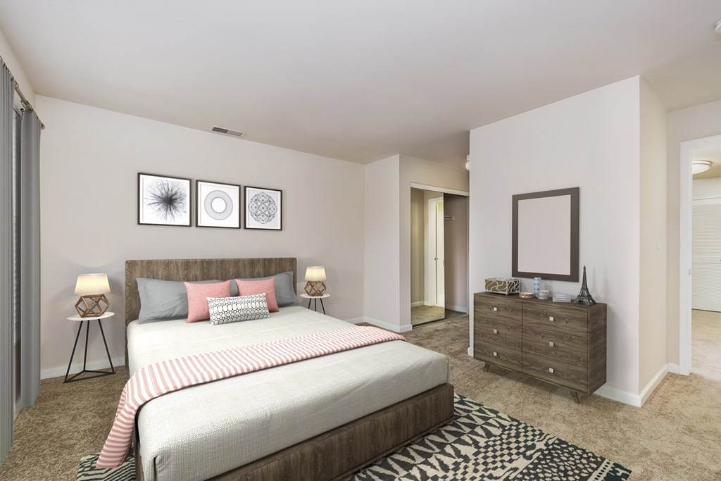 A bedroom with a large bed, a dresser, and a rug.