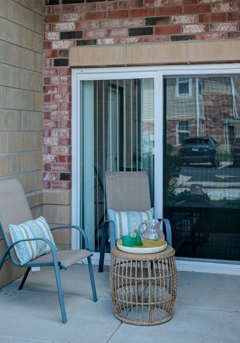 outdoor furniture on the back patio of an Algonquin Square apartment home