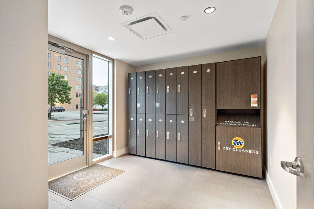 a hallway with lockers and a door to a building